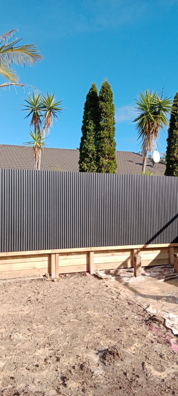 Modern black vertical-slat privacy fence