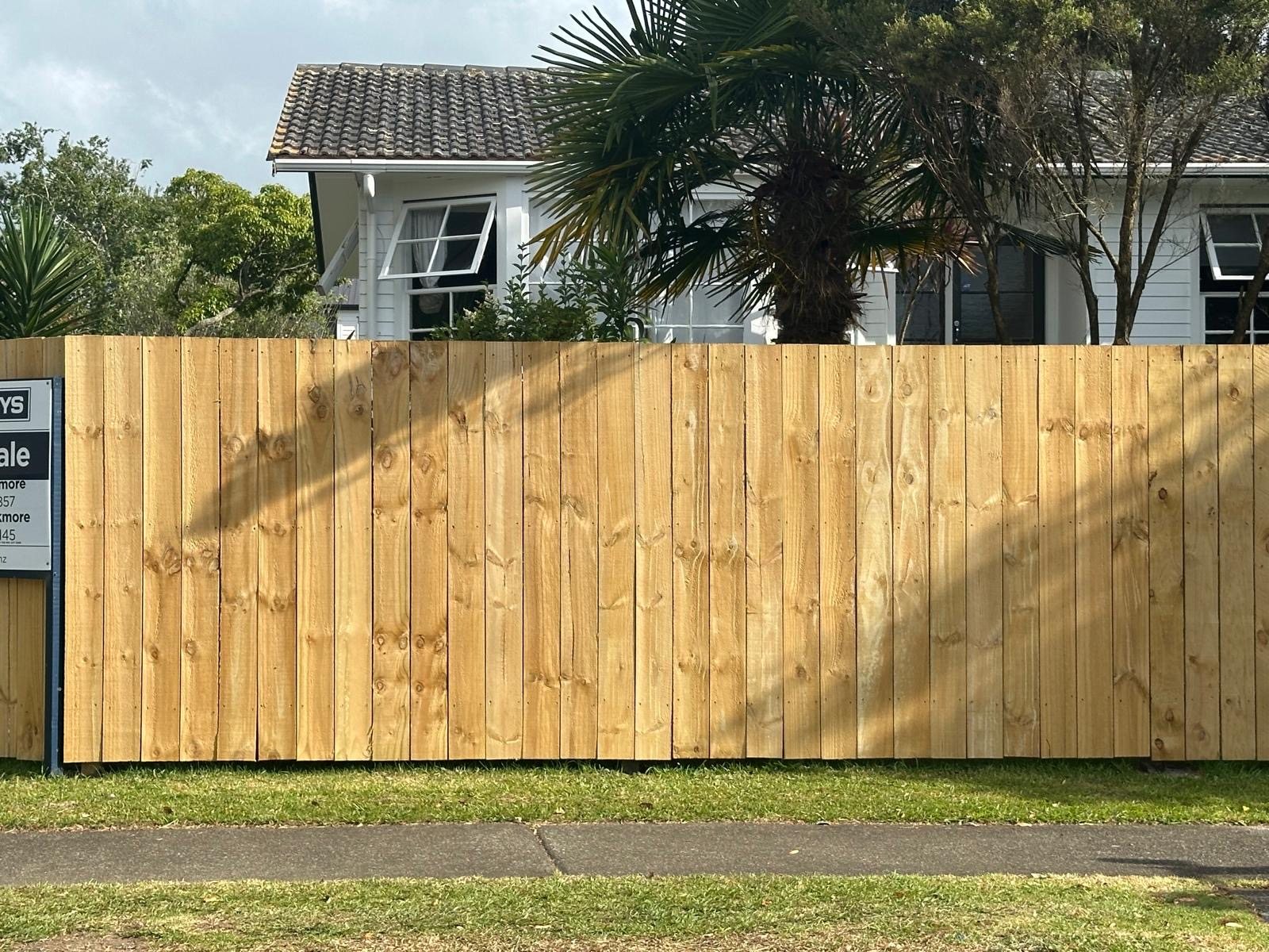 Completed timber boundary fencing running along an Auckland residential section