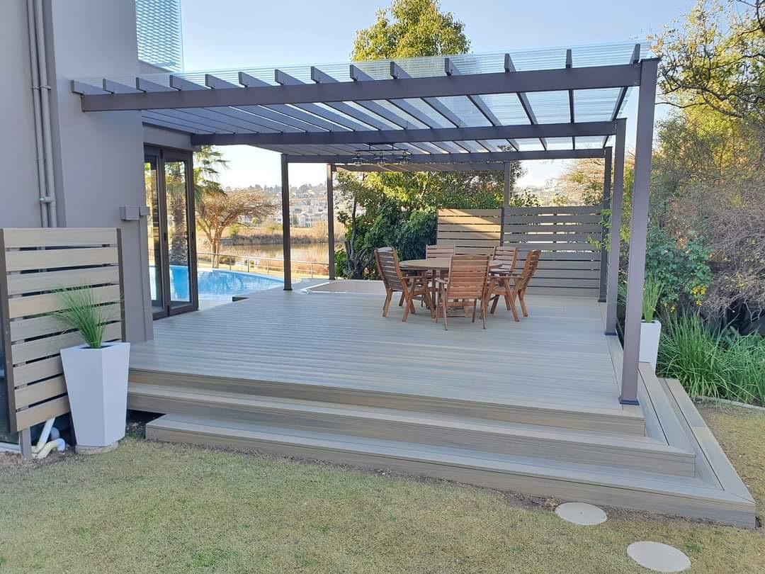 Wide view of a completed garden pergola and composite entertaining deck