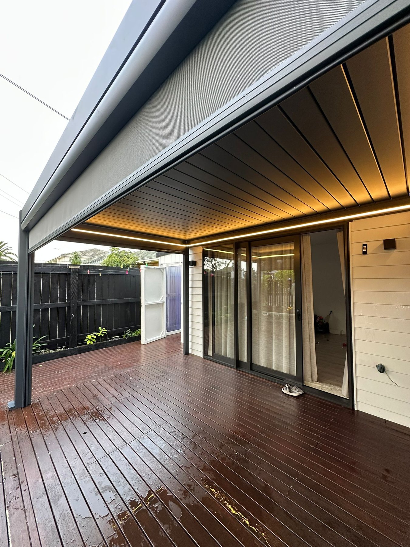 Completed louvred pergola with integrated lighting over a timber deck in Auckland