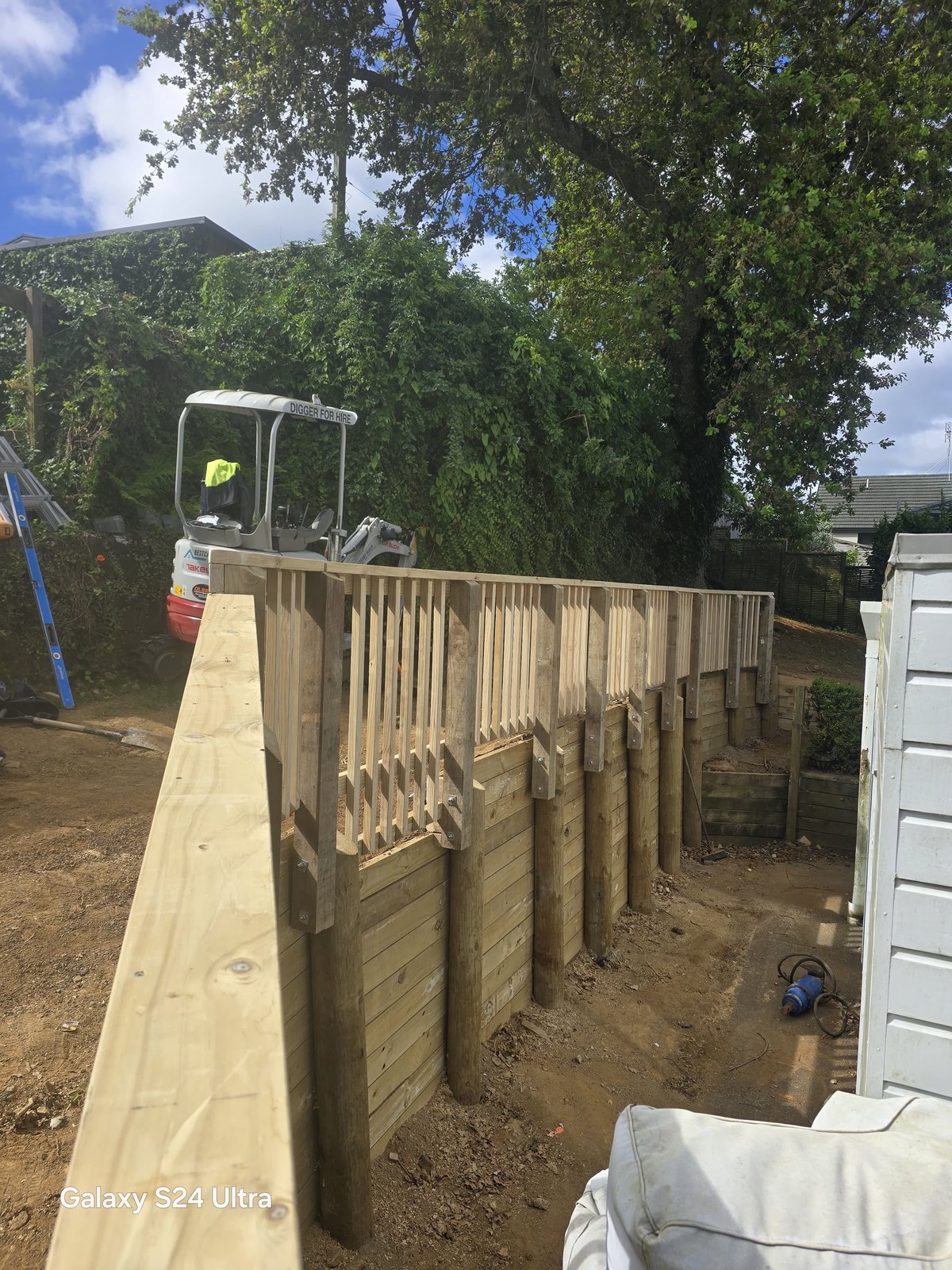 Timber retaining wall and boundary fence viewed from the finished end section