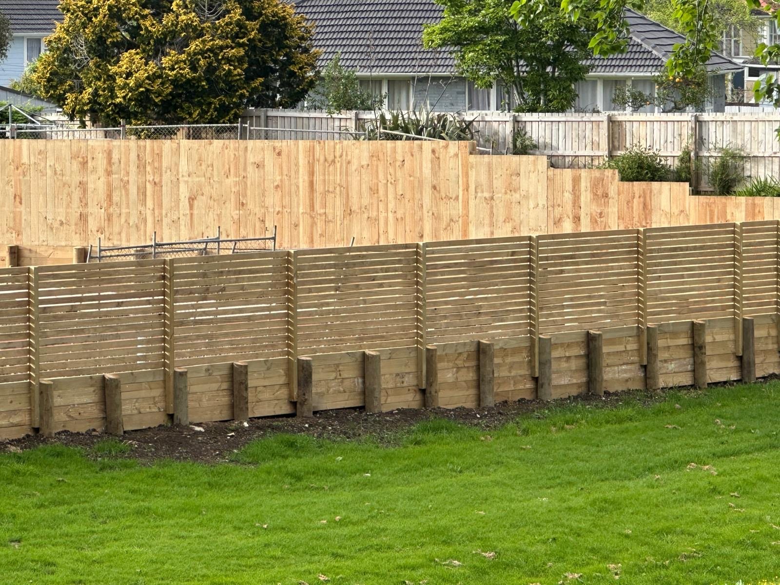 Completed timber retaining wall and boundary fence combination by Bestcare Build