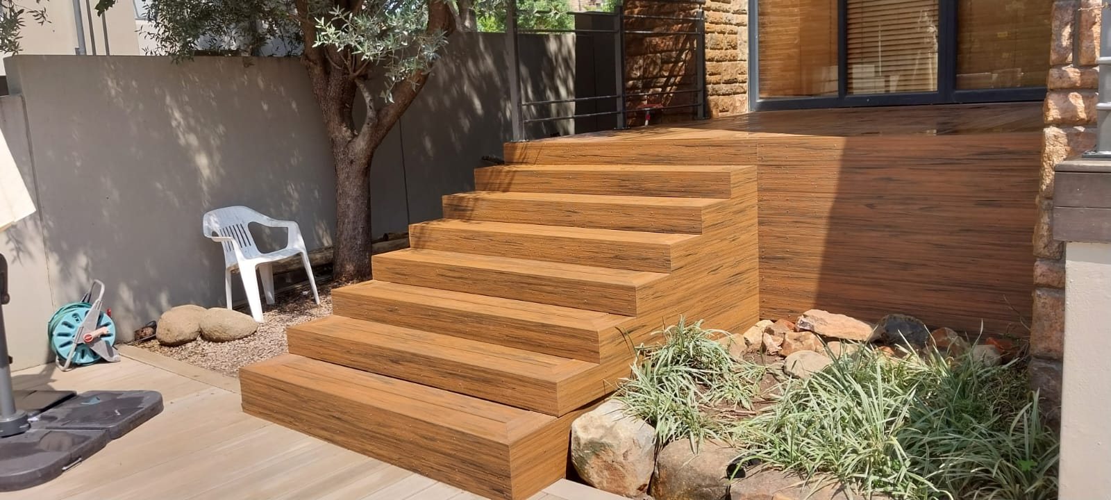 Custom timber deck steps built around an Auckland home and garden